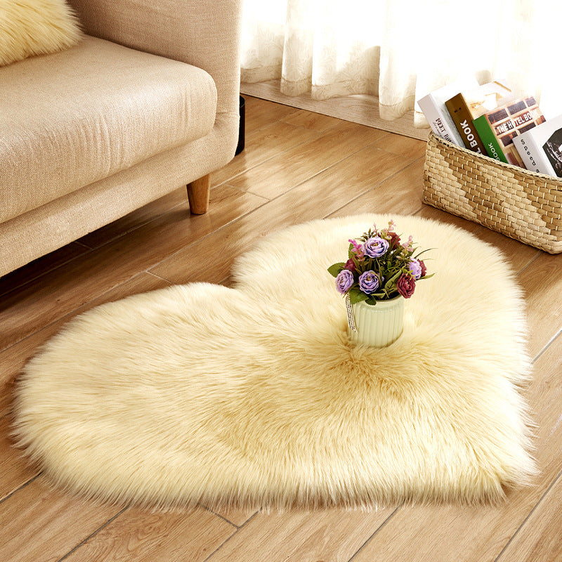 Cream heart-shaped plush rug with dense long shag fibers and fringe