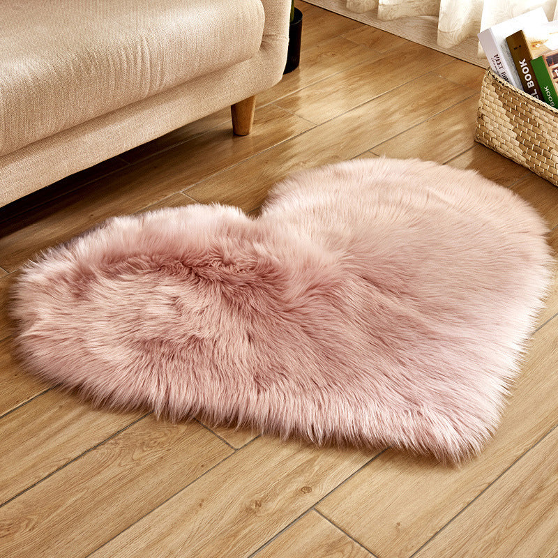 Pink heart-shaped plush rug with fluffy long-pile texture for soft floor comfort