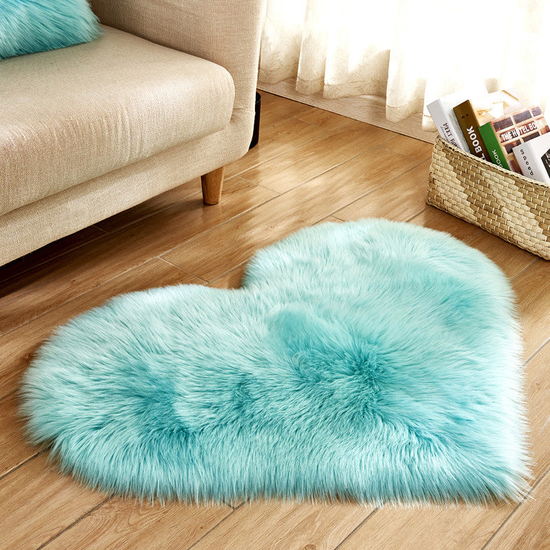 Light turquoise heart-shaped rug with thick long-pile texture and centered tuft