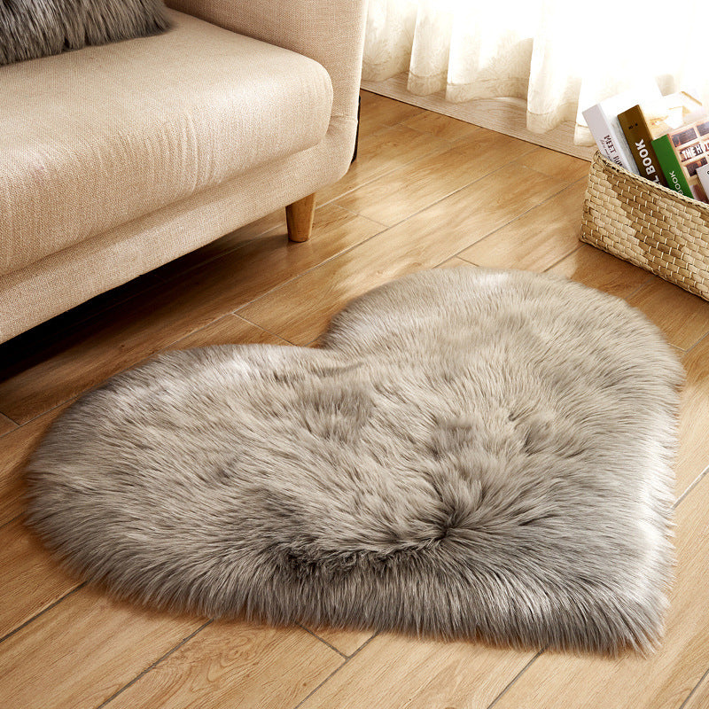 Heart-shaped plush rug with long shaggy pile, light gray