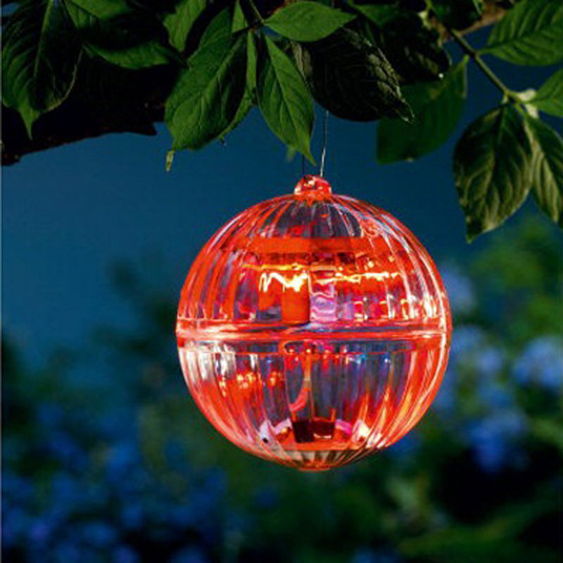 Floating solar LED garden lamp ball with bright red glowing dome and hanging cord