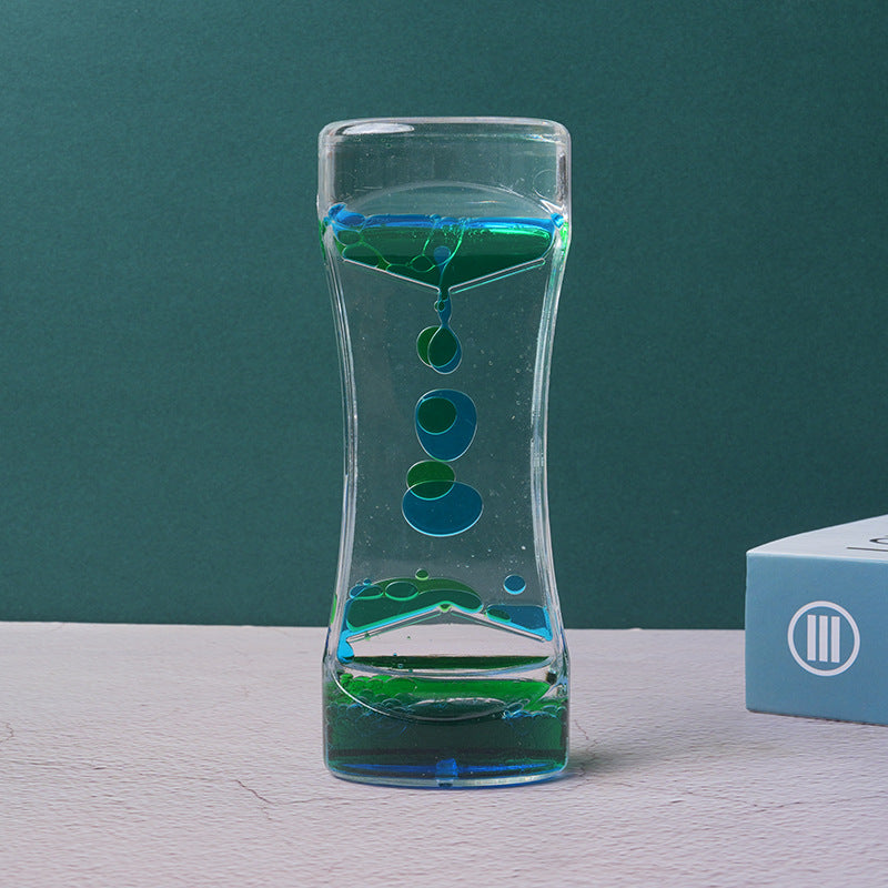 Two-color liquid hourglass timer with teal-green top and green base, floating colored beads