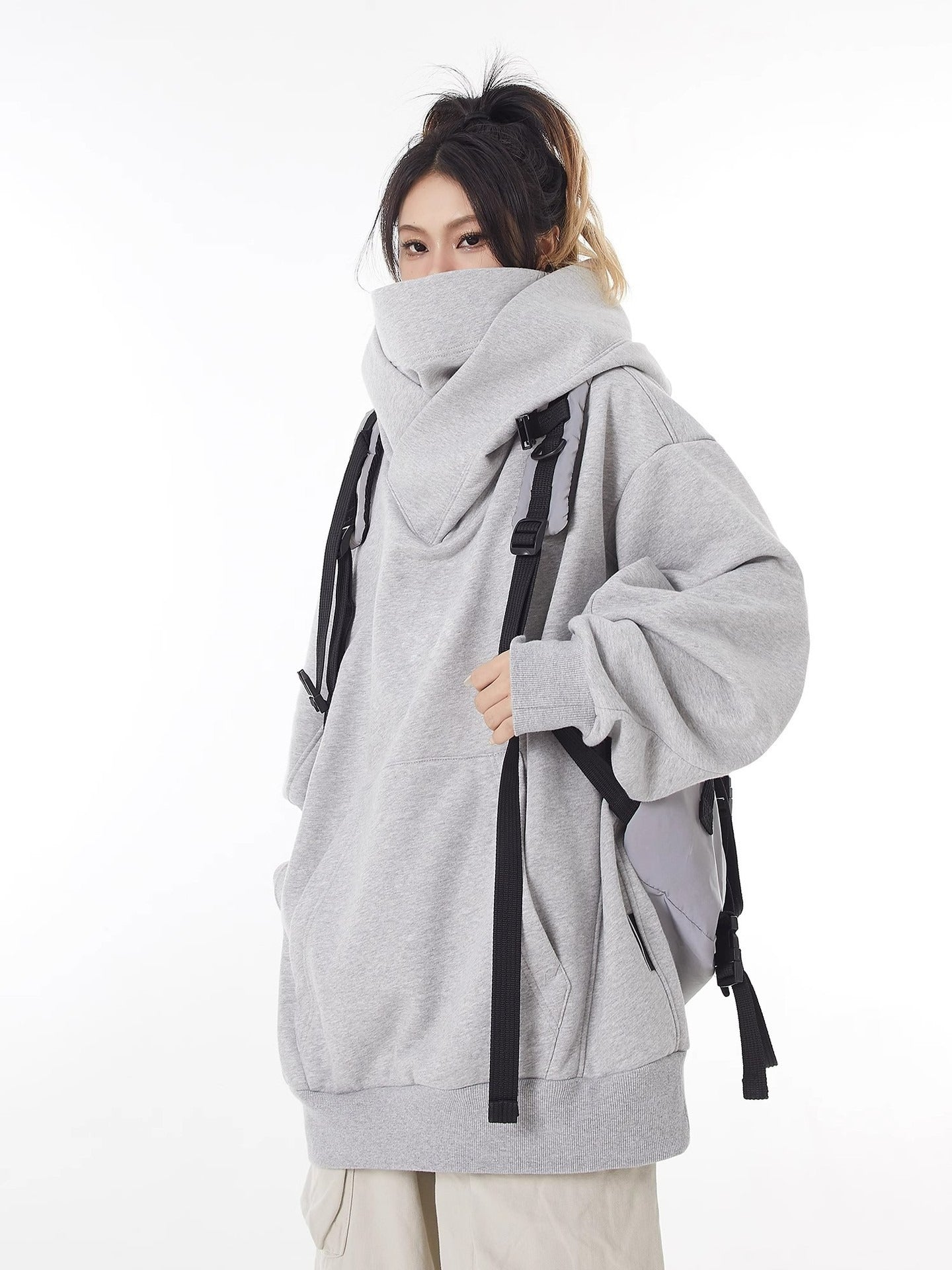 Gray high-collar hoodie with oversized hood, front pouch pocket, and loose sleeves