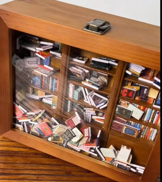 Brown wooden bookcase cabinet with glass doors, stocked with books and magazines