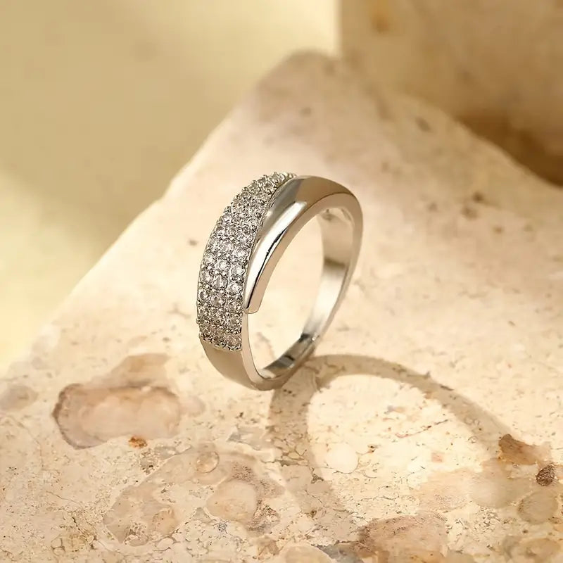 Silver-tone pavé band ring with shimmering stones, smooth inner curve