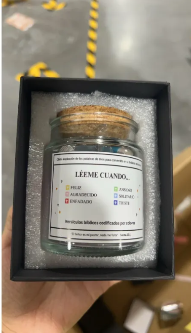 Small glass jar of folded scripture cards inside a black gift box.