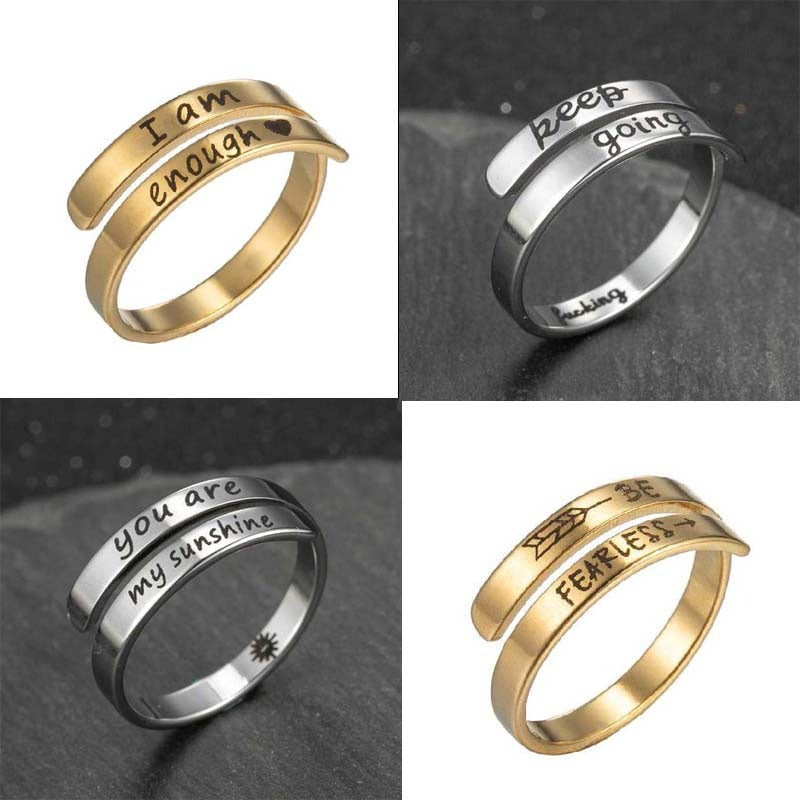 Gold-tone engraved double ring band with text "I am enough" and arrow detail