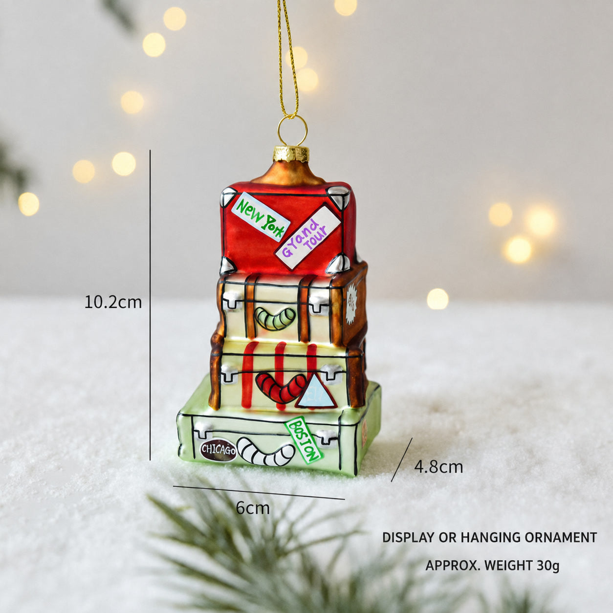 Colorful house-shaped hanging ornament with gold top, red details and hanging loop