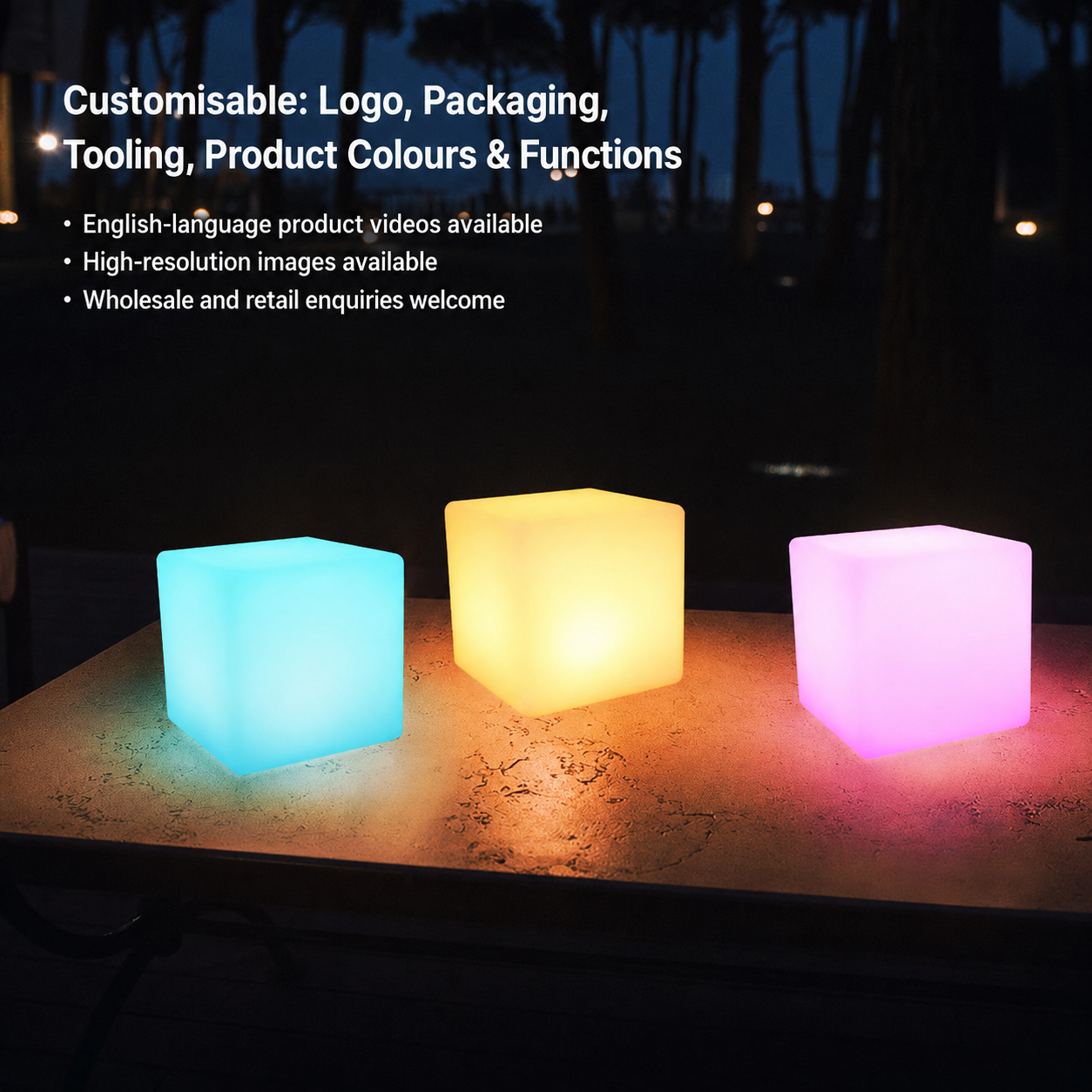 Three glowing cubes in blue, yellow, and pink on a table at night, text in top left corner.