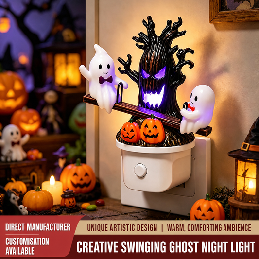 Halloween-themed night light with ghost figures, glowing tree, and pumpkins on a wall socket.
