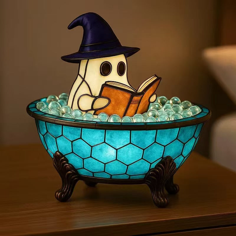 Reading ghost night light in teal tiled cauldron with black legs and open book