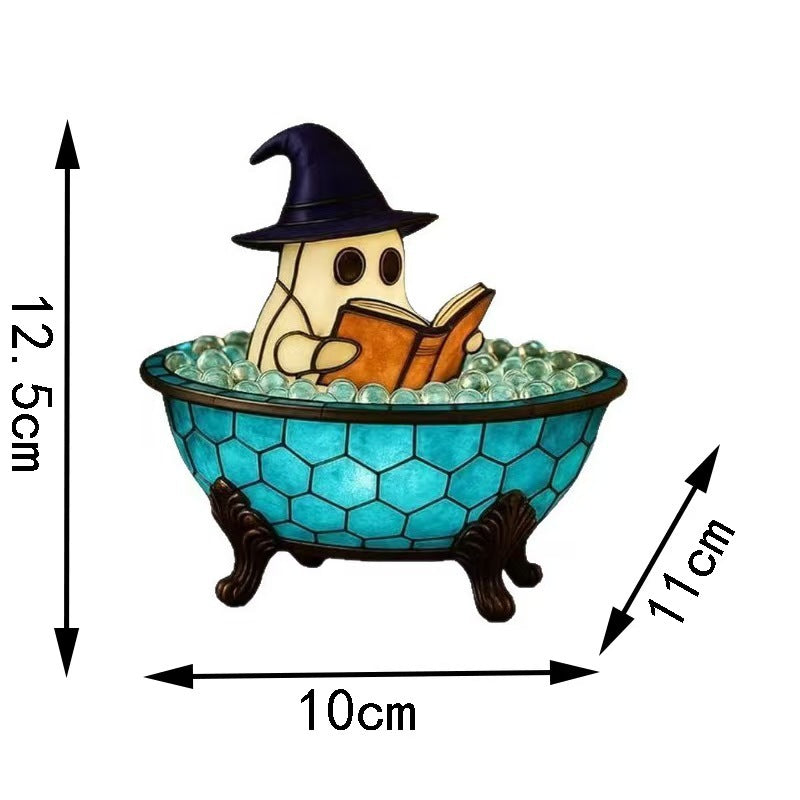 Reading ghost night light in blue cauldron base with glowing teal gems and open book