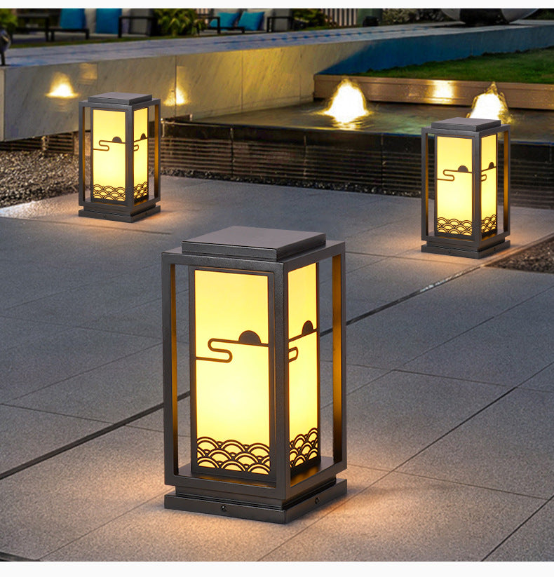 Solar lantern light with black frame on patio, warm light and decorative bottom grille