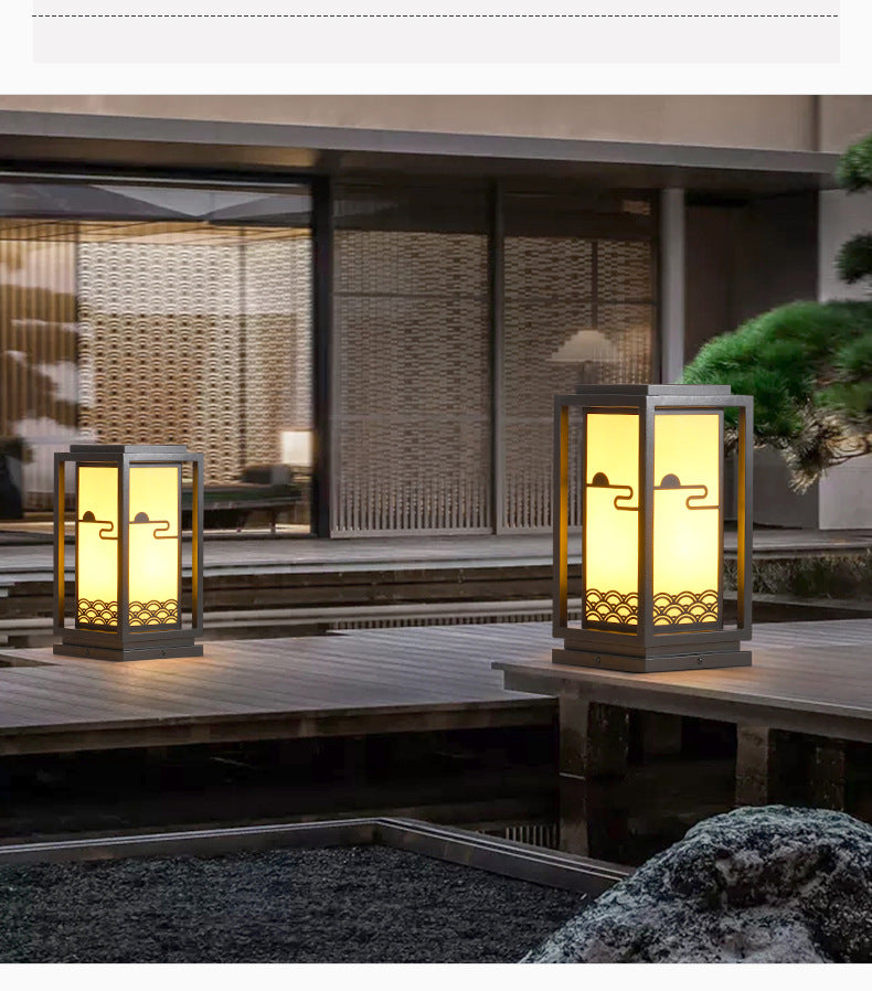 Solar lantern light pair with black frames on outdoor steps, warm interior glow