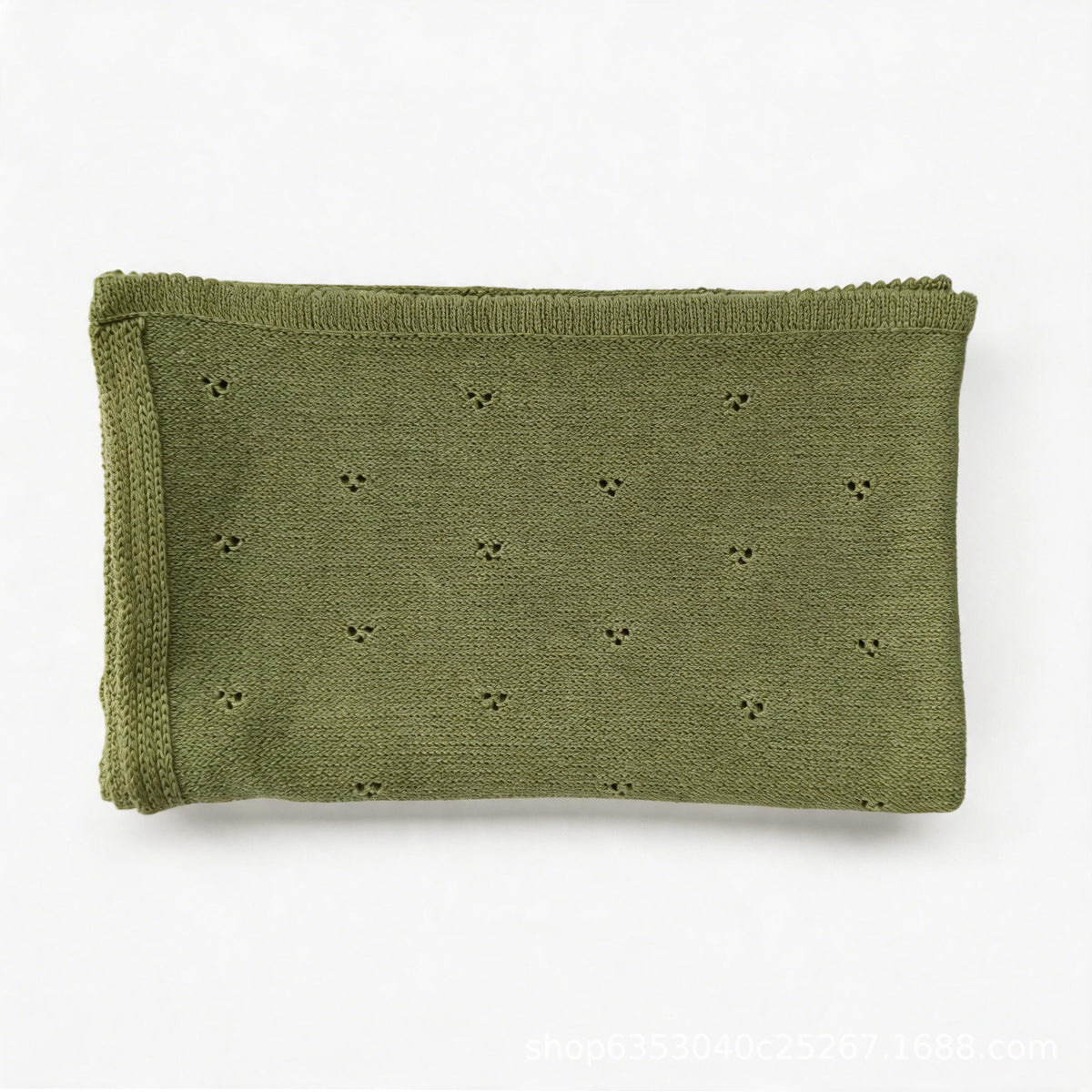 Green cotton baby blanket with small embroidered floral motifs