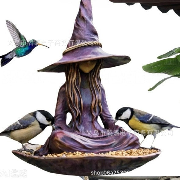 Purple witch-hat bird feeder bowl with gold trim and three blue-and-white songbirds