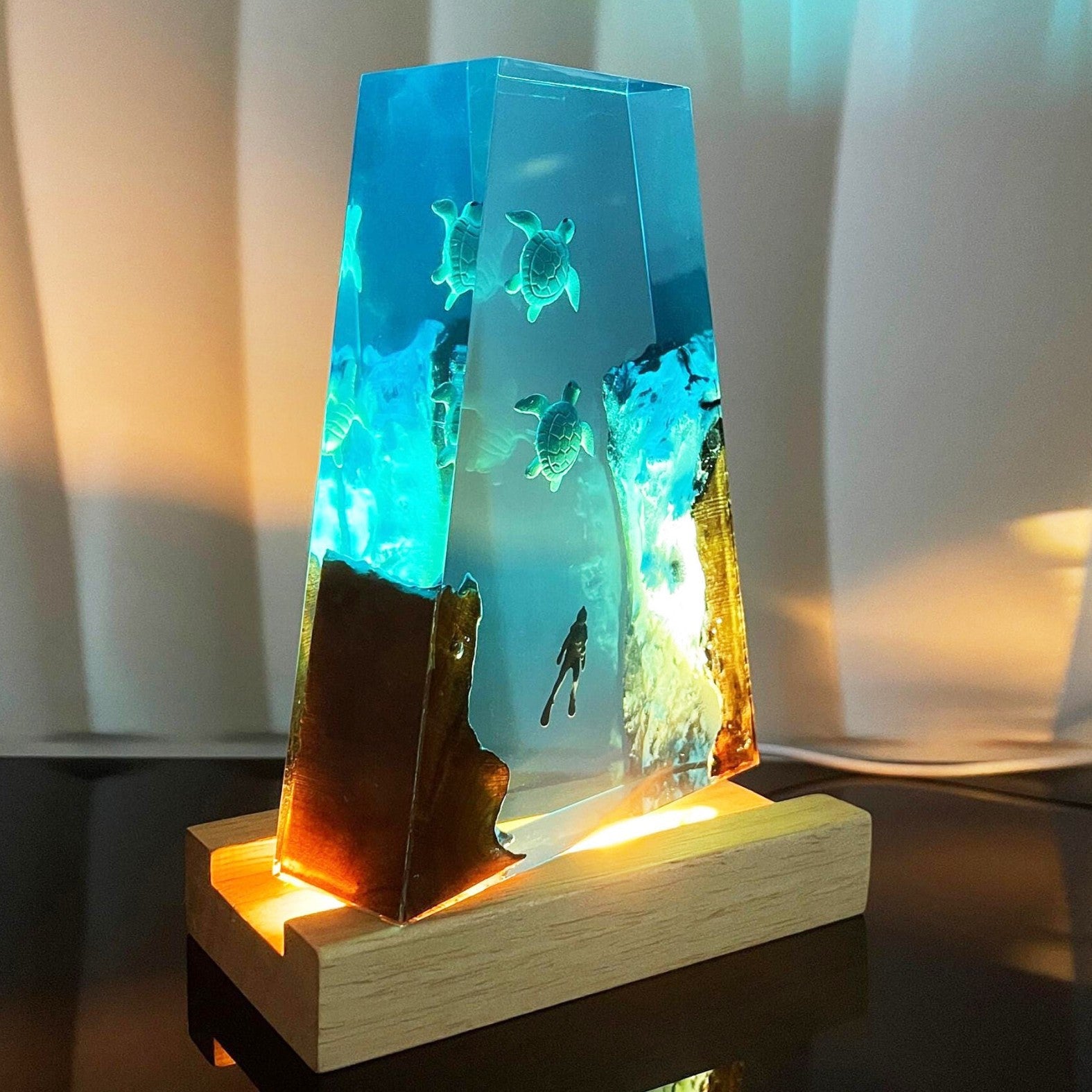 Wood night lamp showing blue resin block with sea turtles