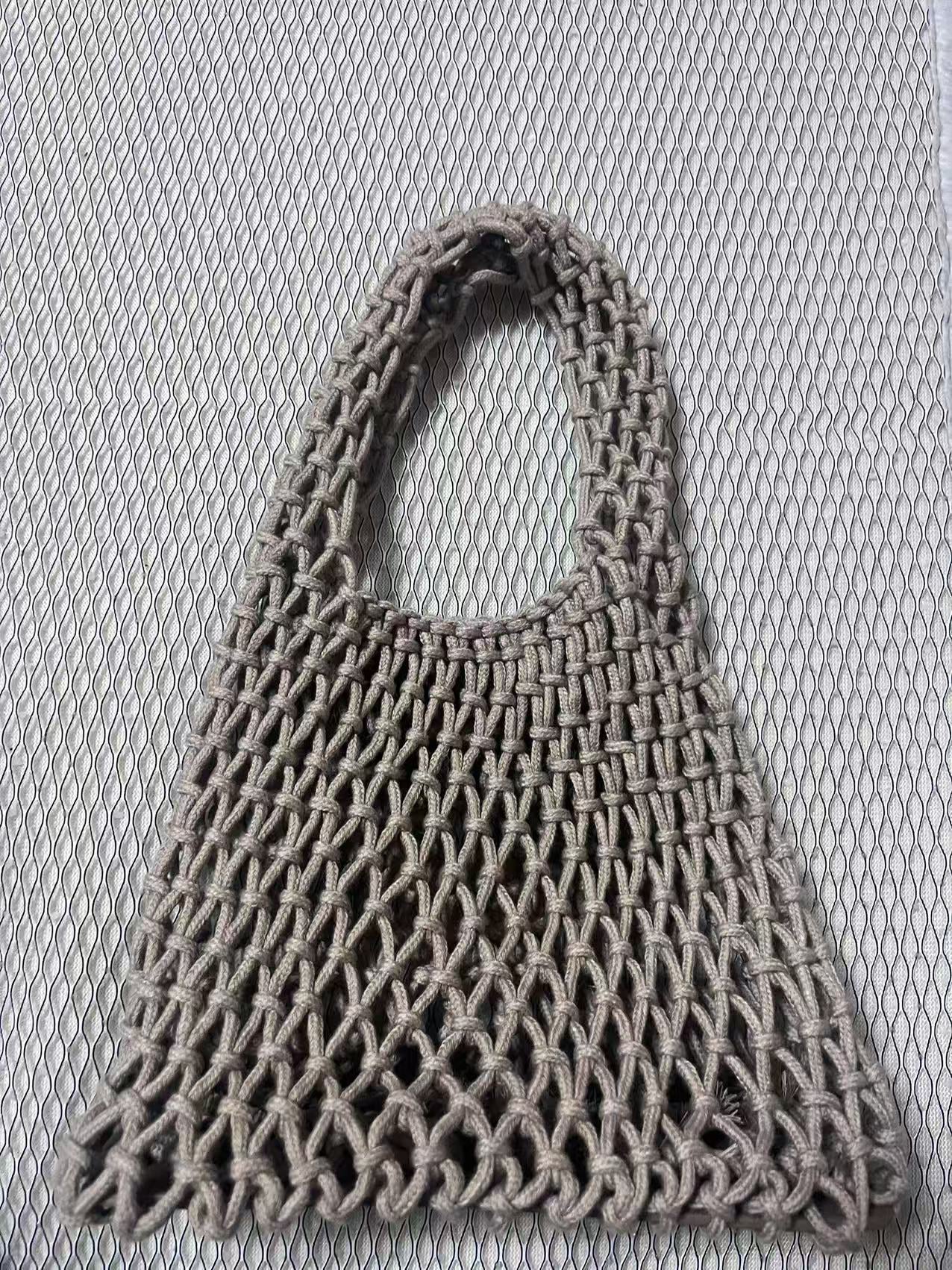 Dark gray rope bucket bag with loop handle and textured net weave, scalloped bottom