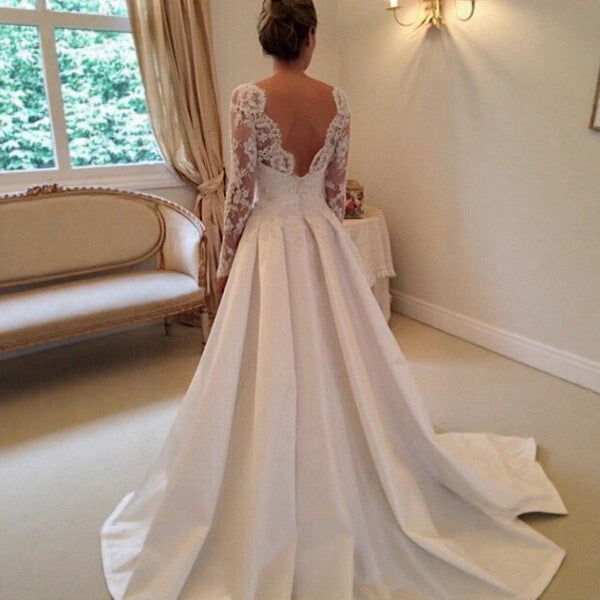 Back view of ivory lace wedding dress with illusion lace back and flowing long train