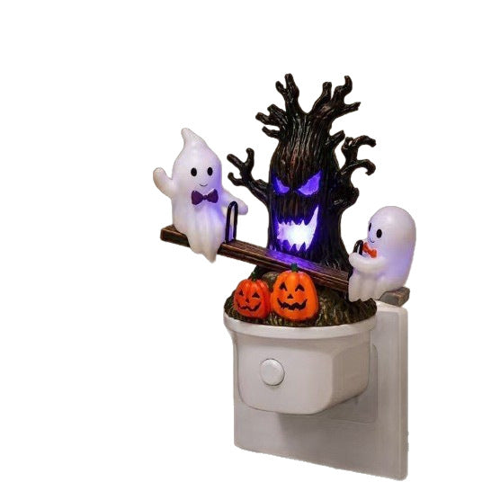 Swing ghost night light with purple glowing tree, two white ghosts, and jack-o’-lantern pumpkins