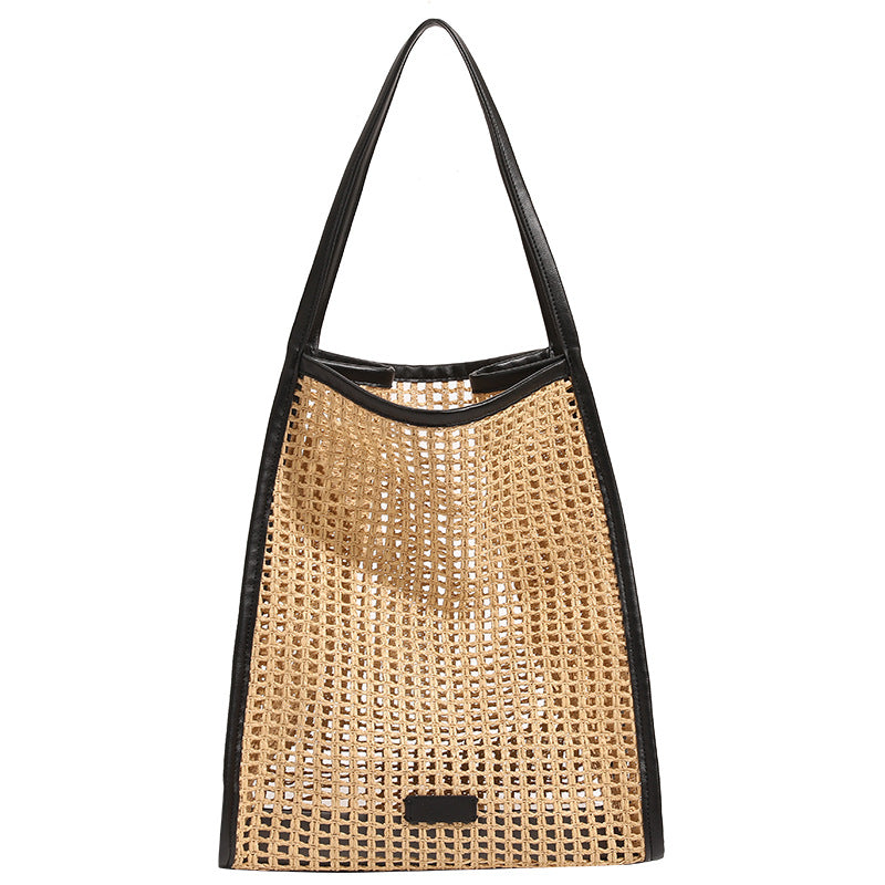 Woven straw tote bag with black top band and wide shoulder straps, open front