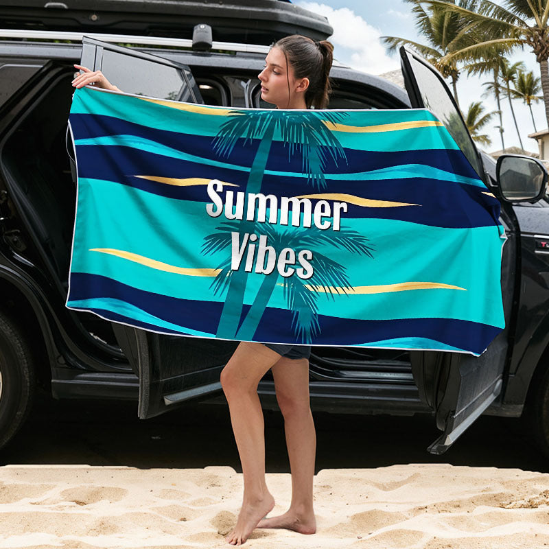 Quick-dry microfibre beach towel, blue striped with palm design, held up