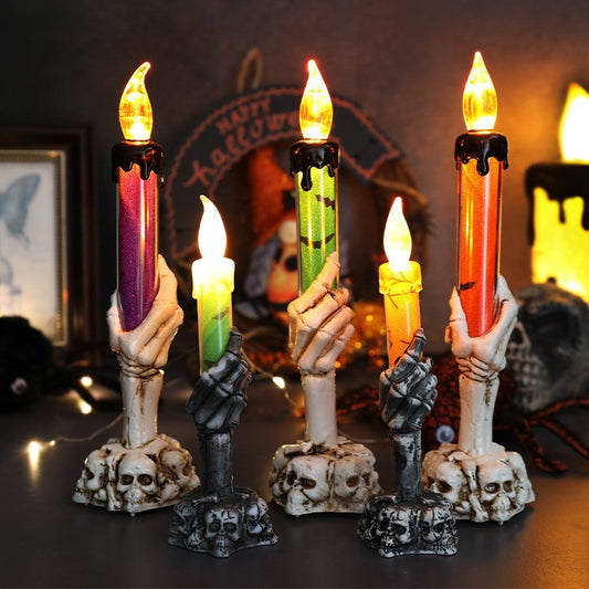 Set of LED ghost hand candles with skull bases and orange flickering flames