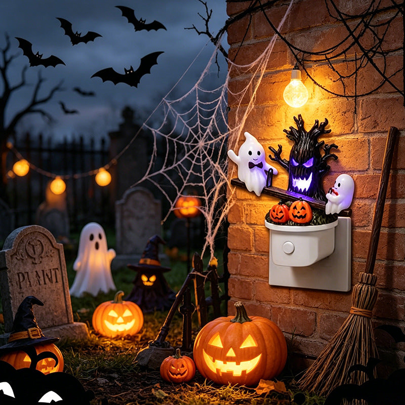 Halloween night light on wall with glowing haunted tree, three ghosts, and carved pumpkins