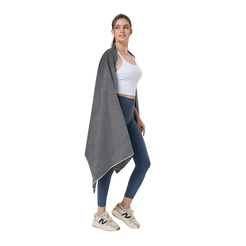 Quick-dry microfibre beach towel, dark gray, draped over a person
