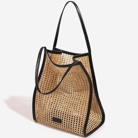 Woven straw beach tote bag with black trim, open top, shoulder handles