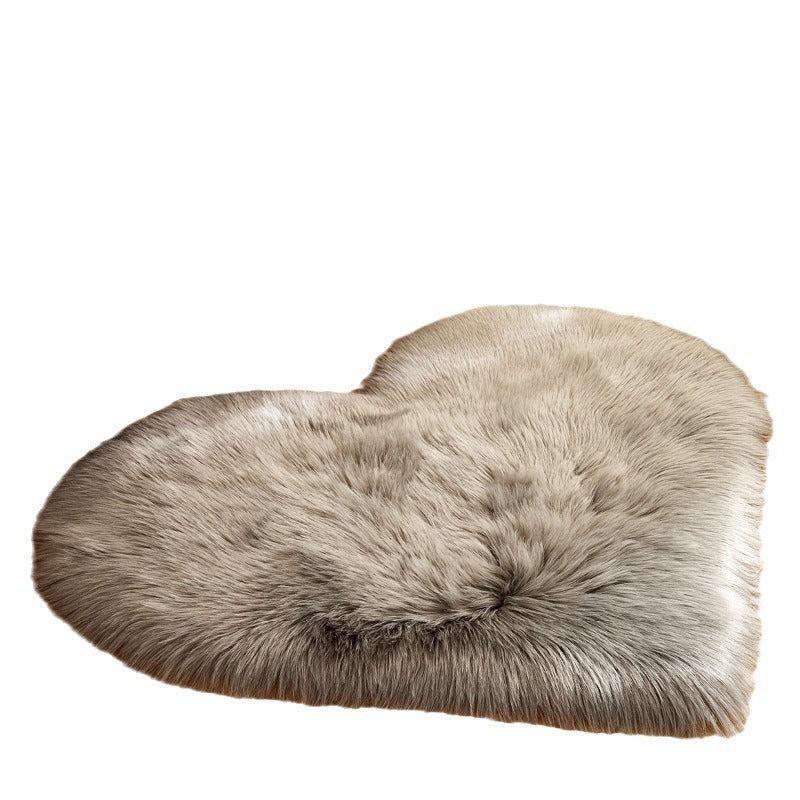Gray heart-shaped plush rug with long shaggy pile, fluffy texture