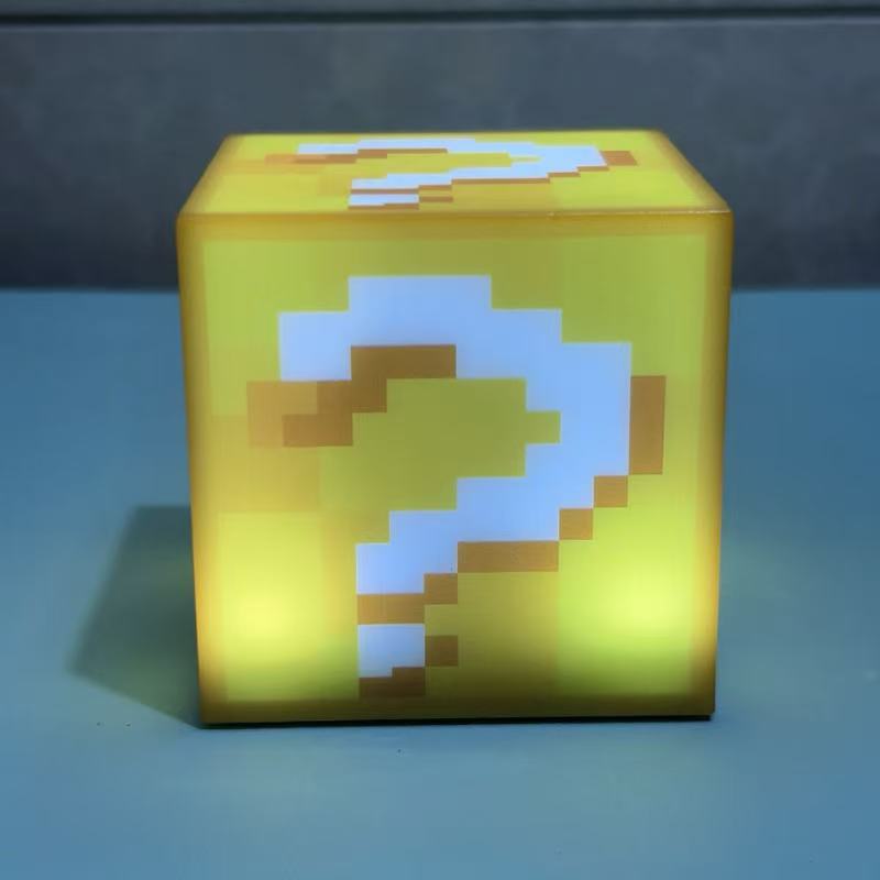 Yellow Minecraft-style cube night light with green, white, and brown pixel pattern