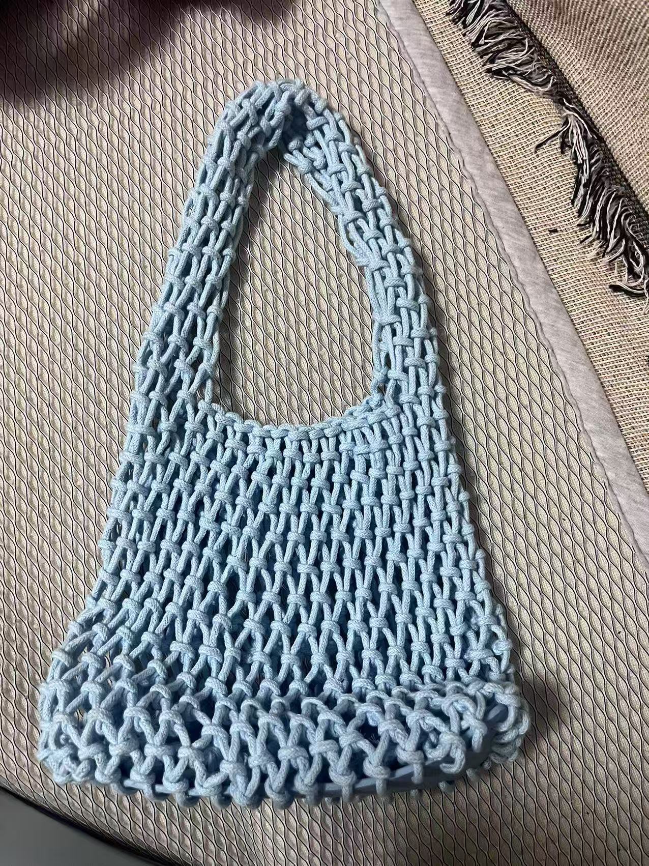 Light blue openwork cotton rope bucket bag with braided handle and textured bottom