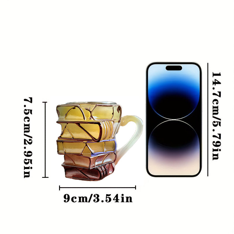 Small resin book-stack mug with pale handle, glossy multicolor finish.