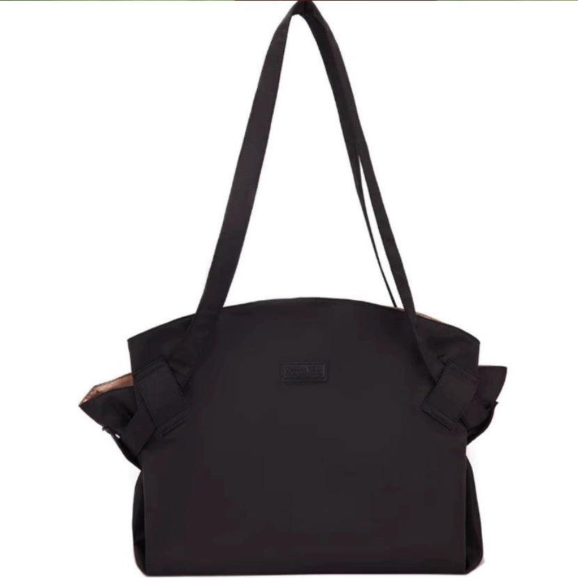 Black large-capacity travel duffel bag with top handles and shoulder strap