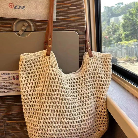 Off-white woven mesh tote bag with open top and brown leather shoulder straps