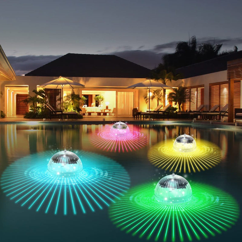 Floating solar LED garden lamps with warm yellow and blue-green glow in pool