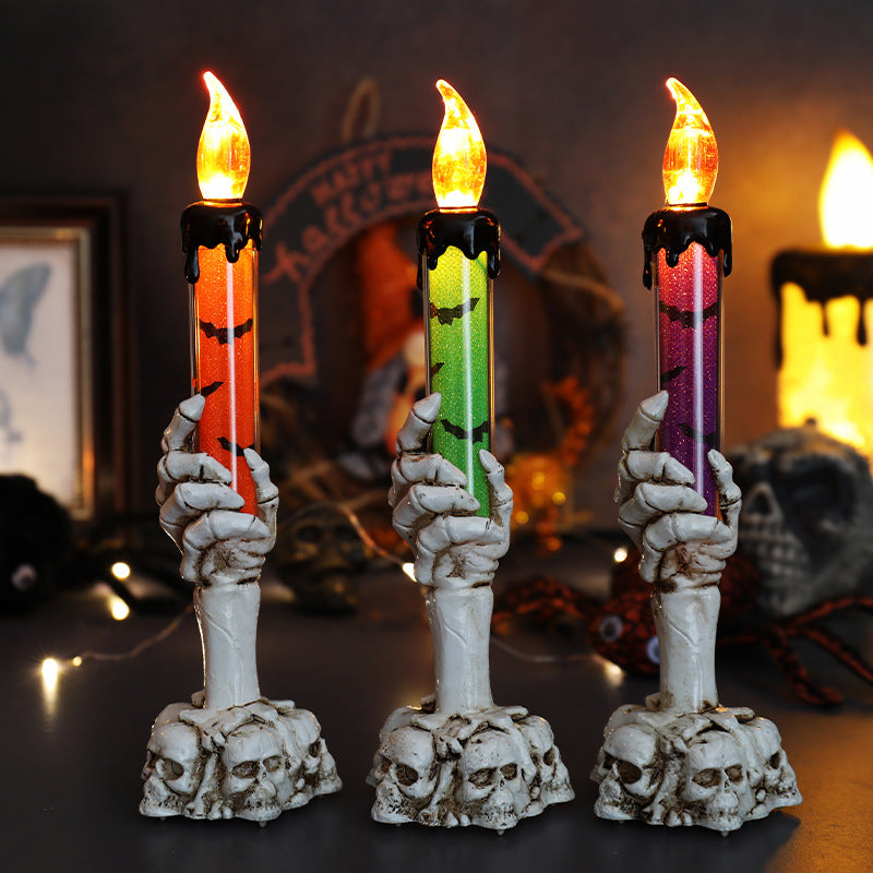 Set of three LED ghost hand candles with skull bases and multicolor flickering flames