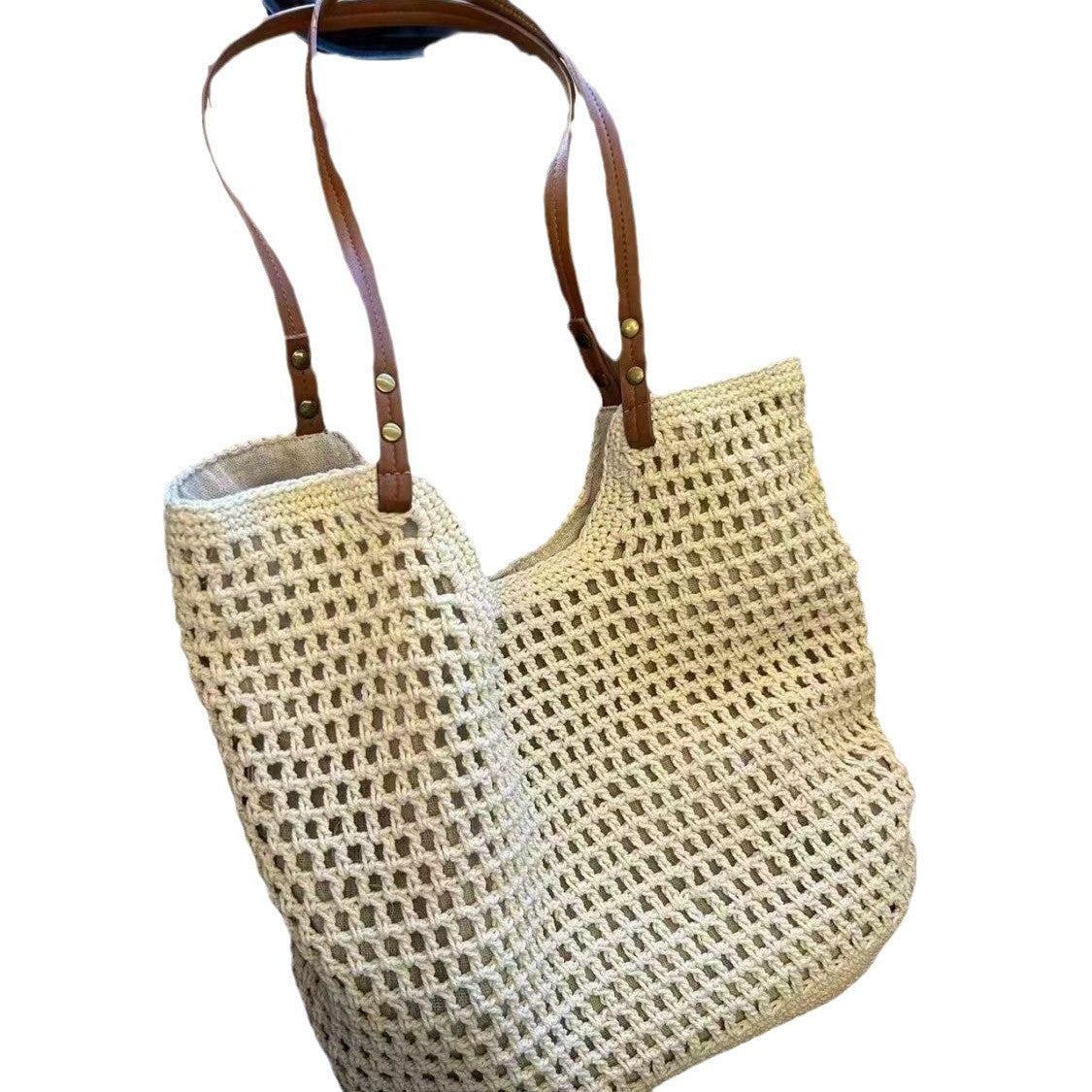 Off-white crocheted mesh tote bag with two long brown leather shoulder straps