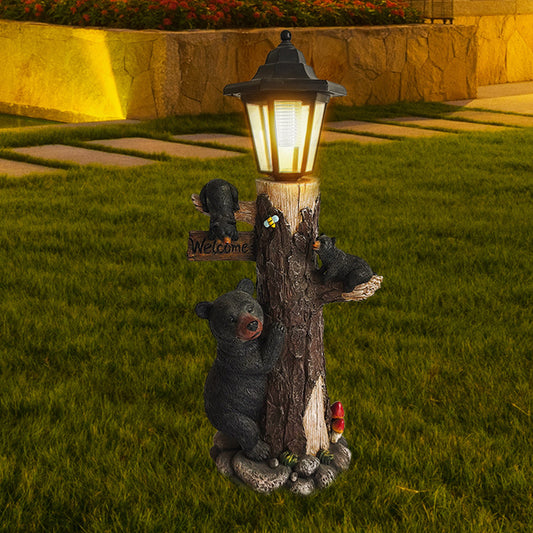 Solar garden light ornament with lantern on a carved wooden log and hugging koalas