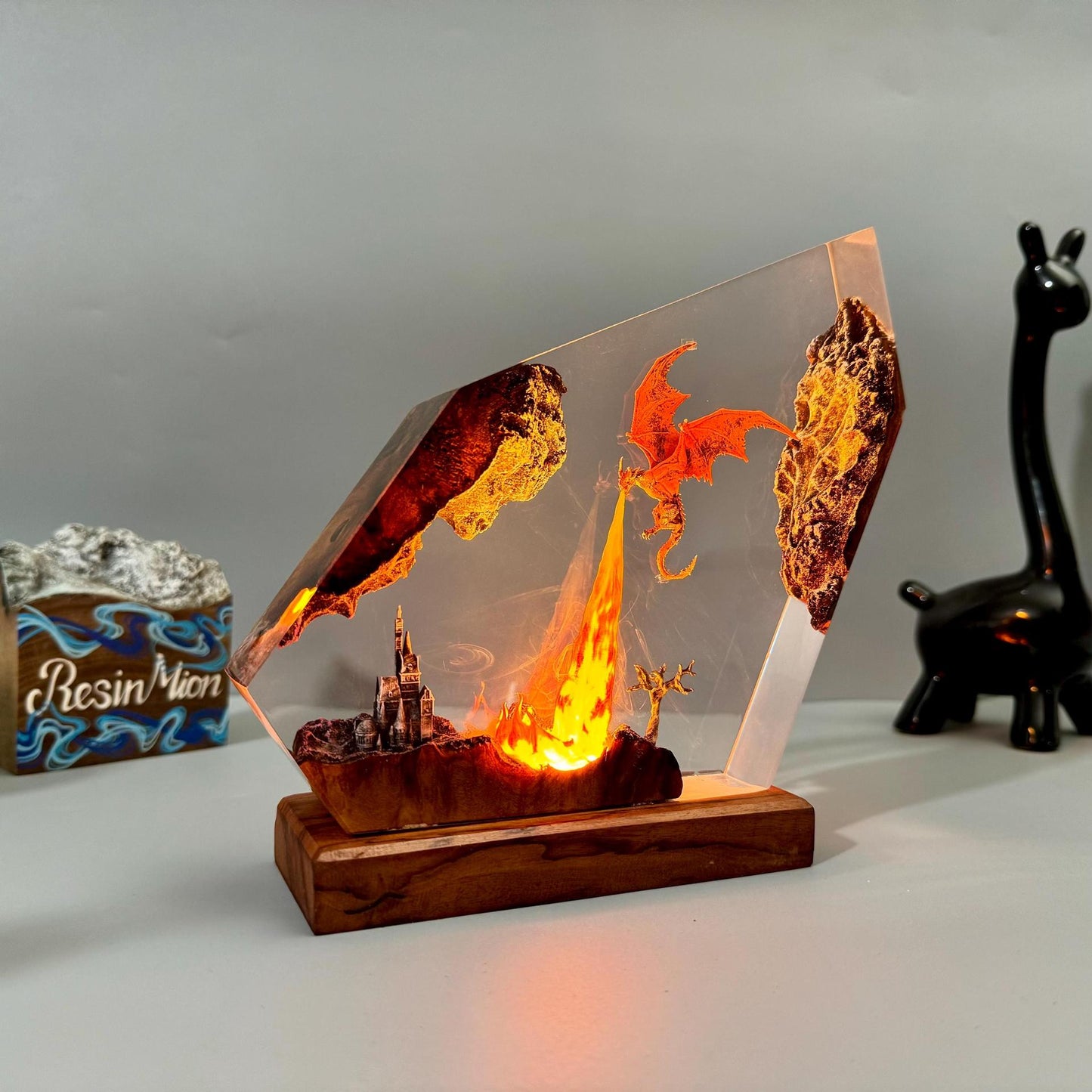 Fire dragon resin art lamp with glowing orange flame scene in clear prism and wood base