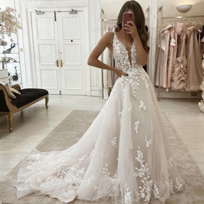 Ivory wedding dress with floral lace applique bodice and elegant sheer tulle train