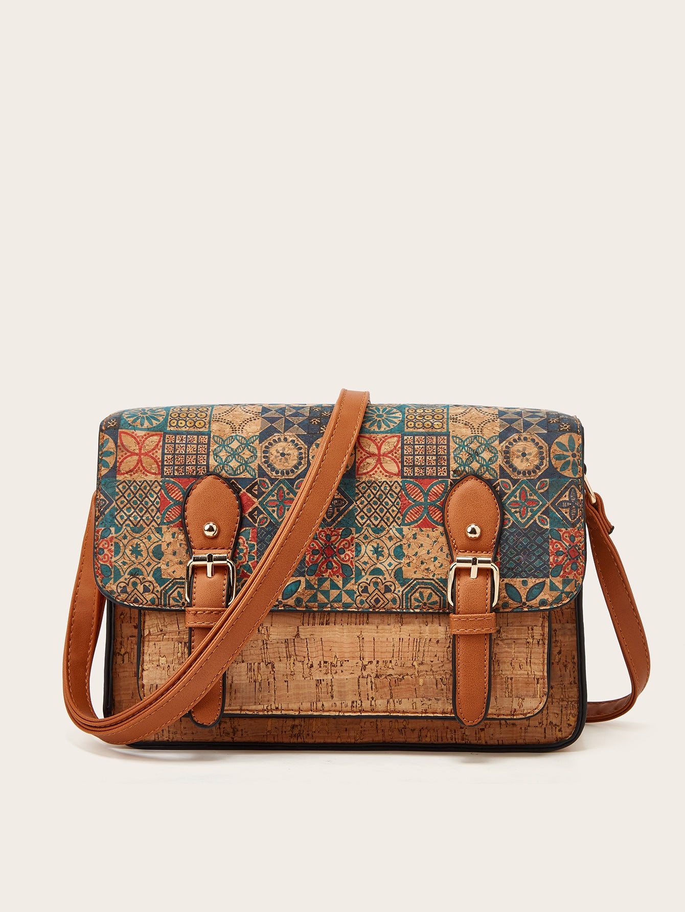 Women’s crossbody messenger bag with teal floral print flap and brown leather straps