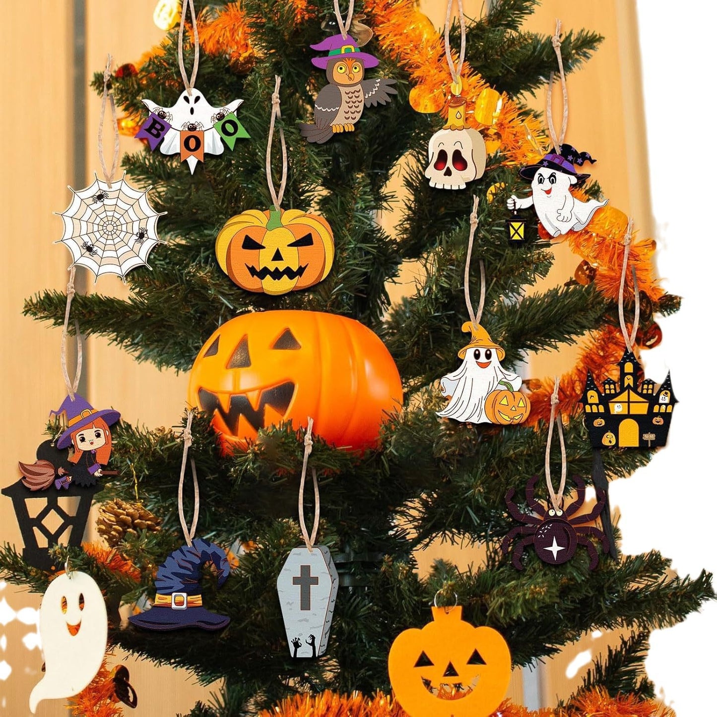 Halloween tree decor with wooden hollow ornaments: jack-o-lantern, ghost, witch hat, spider