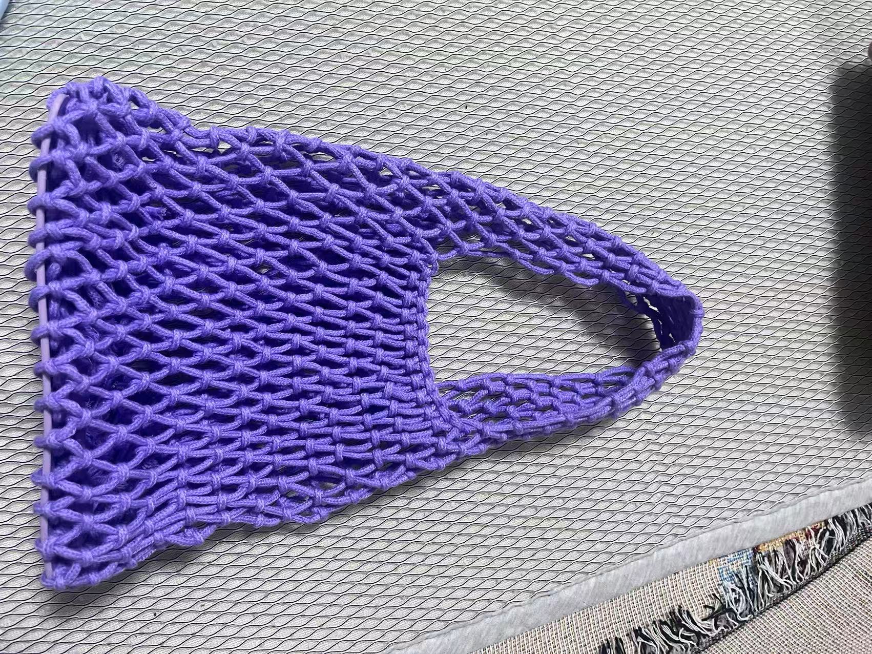 Purple crochet bucket bag with hollow net weave and rounded rope handle