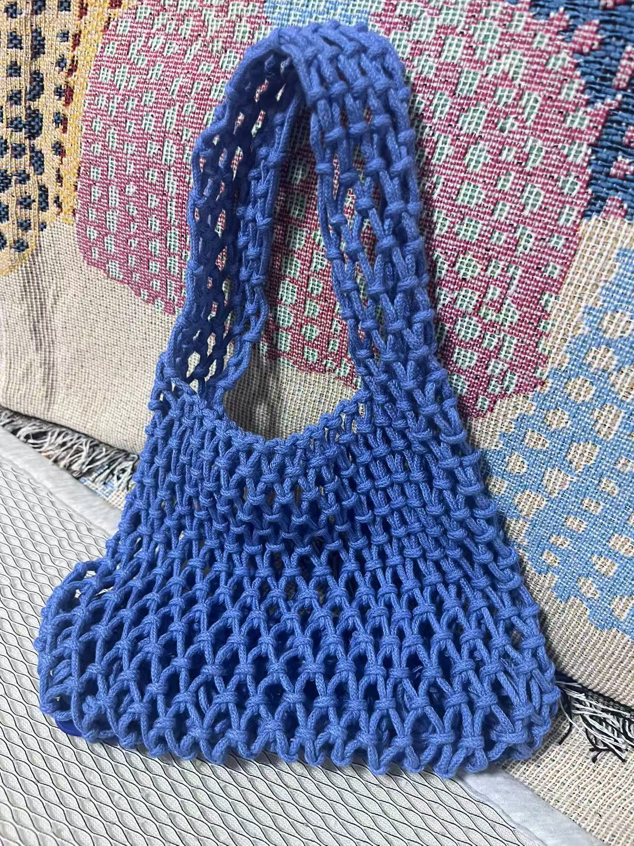 Bright blue woven cotton rope bucket bag with hollow net weave and loop handle.