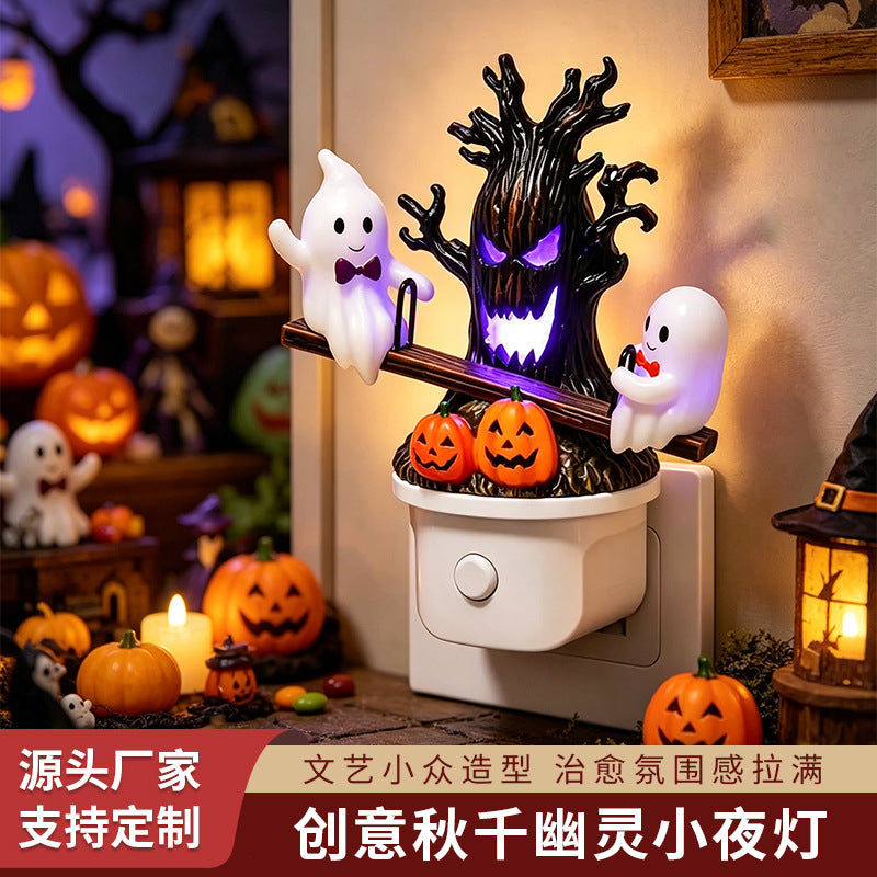Swing ghost night light with purple glowing haunted tree, two ghosts, and jack-o’-lanterns