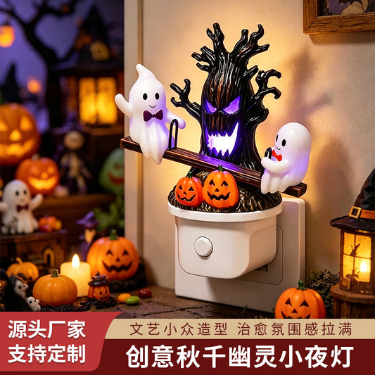 Swing ghost night light with purple glowing haunted tree, two ghosts, and jack-o’-lanterns