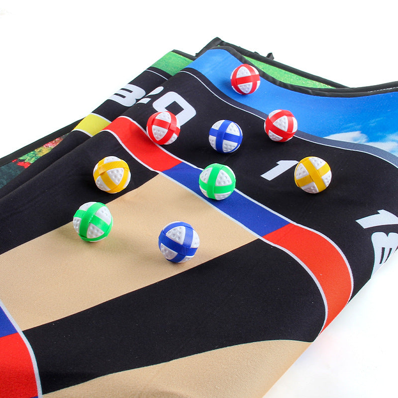 Inflatable-style golf target mat with colorful ball markers on black and blue lanes