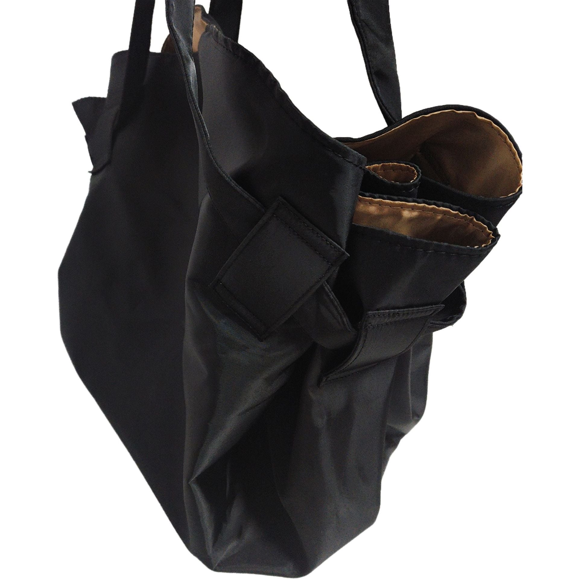 Black travel duffel bag with wide shoulder straps and front pocket